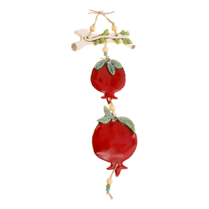 A mobile of two pomegranates on a branch